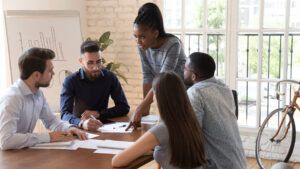Woman leader speaking to group of people in meeting