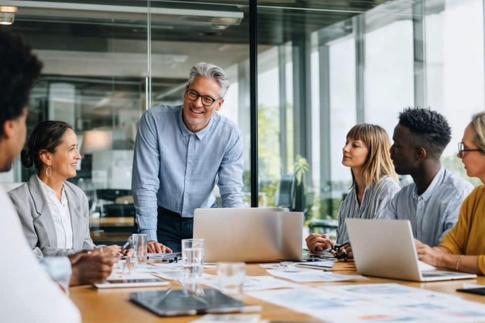 Leader exhibiting strong decision making skills in team meeting